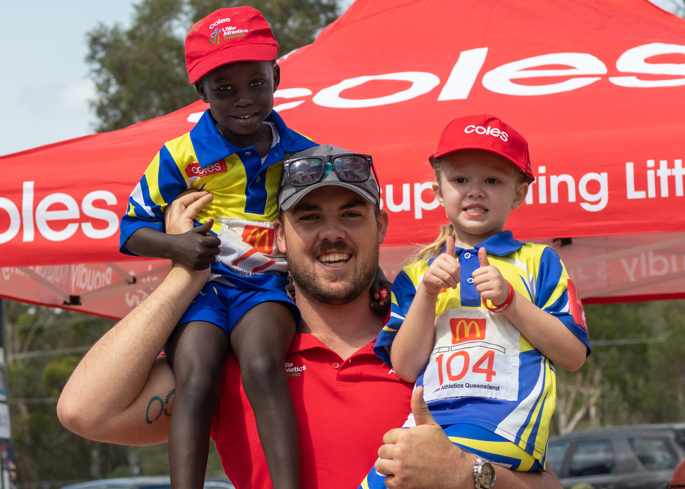 Athlete Matthew Denny with children from Little Athletics Queensland